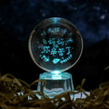 Transparent 6cm white crystal ball ornament with inner carving on a tabletop.