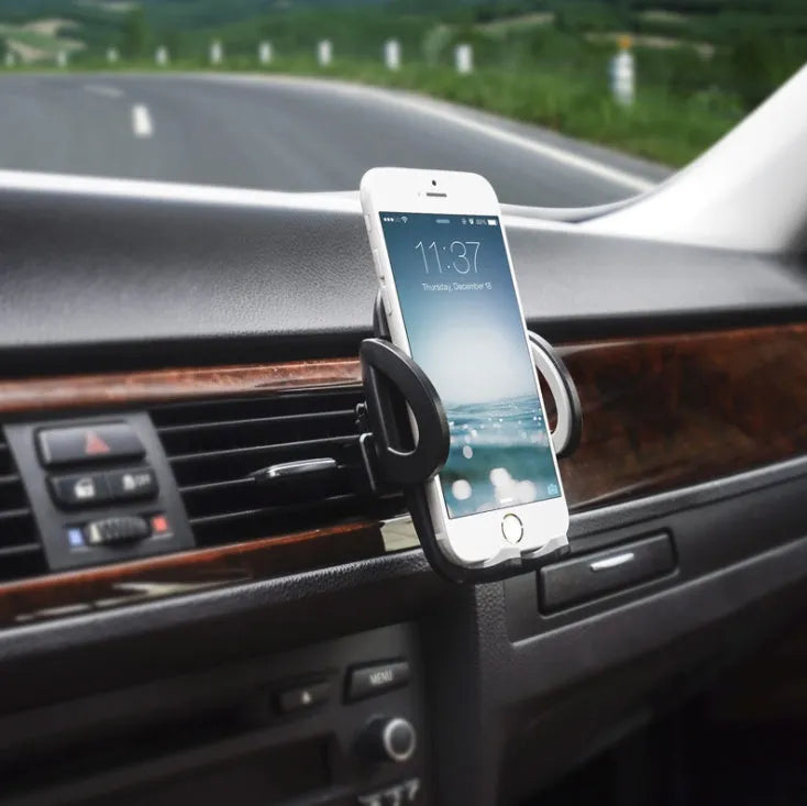Black plastic mobile phone holder attached to car air conditioning vent