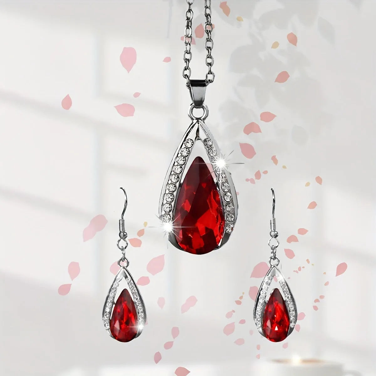 Black and red teardrop glass pendant necklace and matching earrings set made from alloy metal.