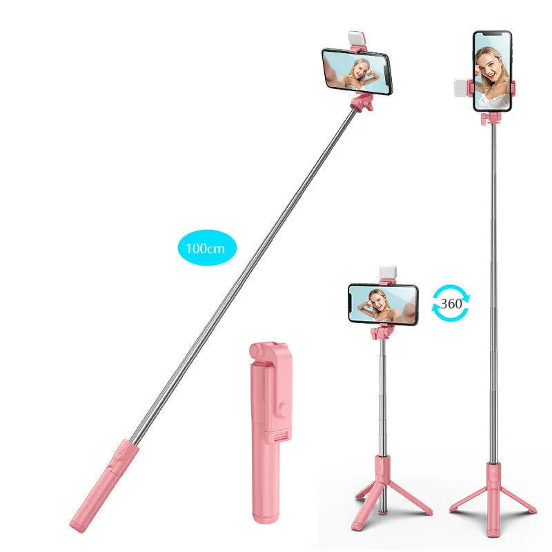 Black Bluetooth selfie stick with extended tripod legs holding an iPhone, showing its 360-degree rotating phone holder.