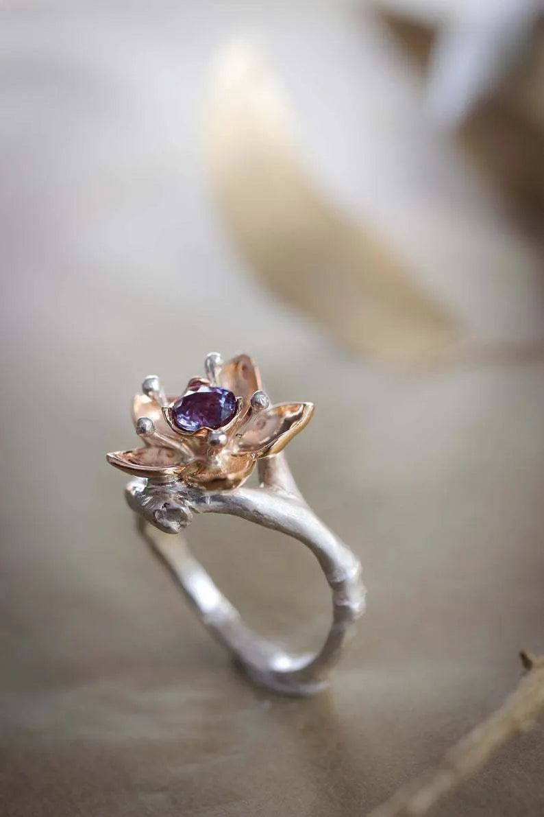 Silver two-tone floral geometric women's ring on display showing geometric shape and floral pattern detail.