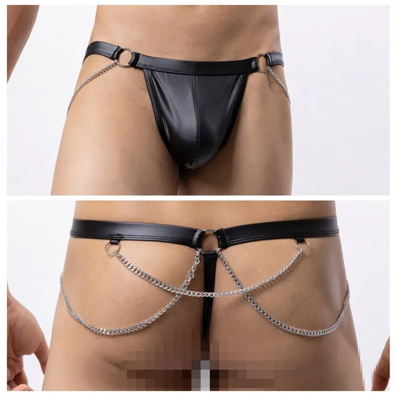 Black patent leather men's thong with a metal chain detail on the back, laid flat.