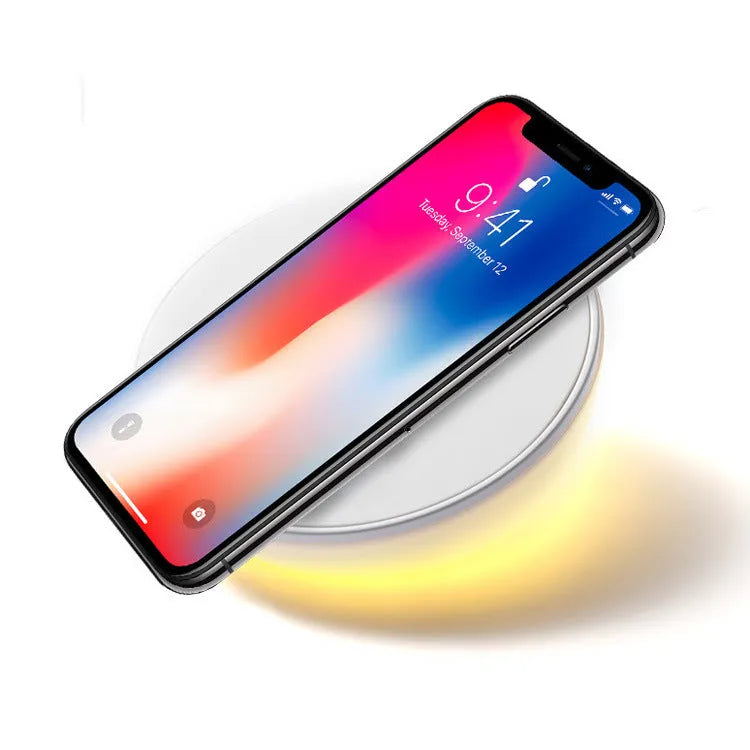 White wireless charging pad with digital clock display and control buttons for QI smartphone charging
