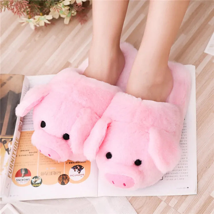 Pink plush pig face design floor slippers on a white background.