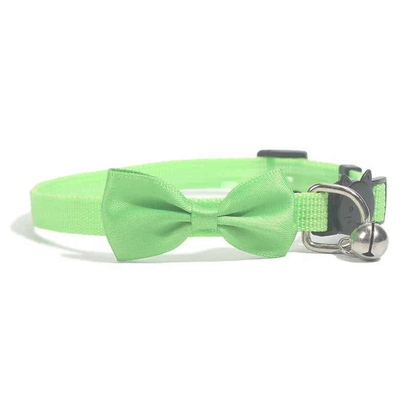 Adjustable nylon cat collar with decorative bow and bell in striped cartoon pattern, multiple colour options shown
