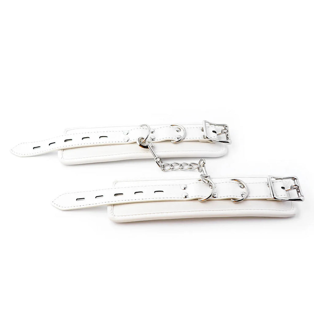 White PU sponge BDSM bondage set showing handcuffs, foot cuffs, and a neck scarf.