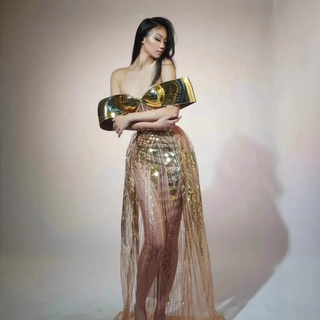 Gold strapless sequin dress with sleeveless tube top and long one-step skirt.