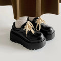 Black matte women's lace-up platform shoes with a chunky 6-8cm rubber sole and round toe.