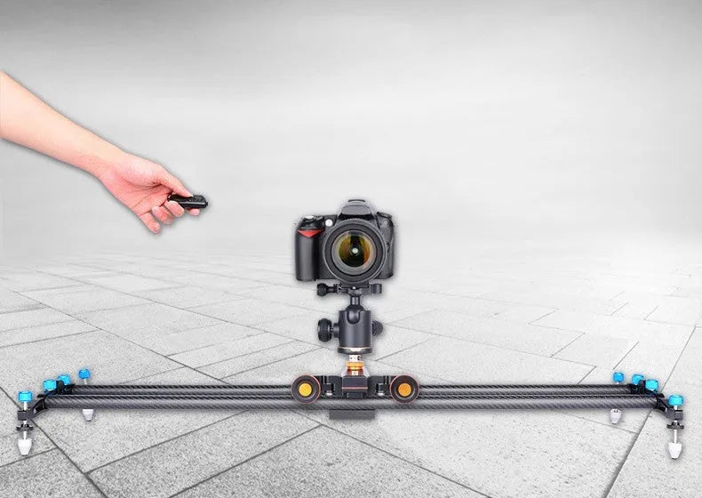 Wolf King L4X mobile camera remote control slide car with black body and silver remote on a tabletop
