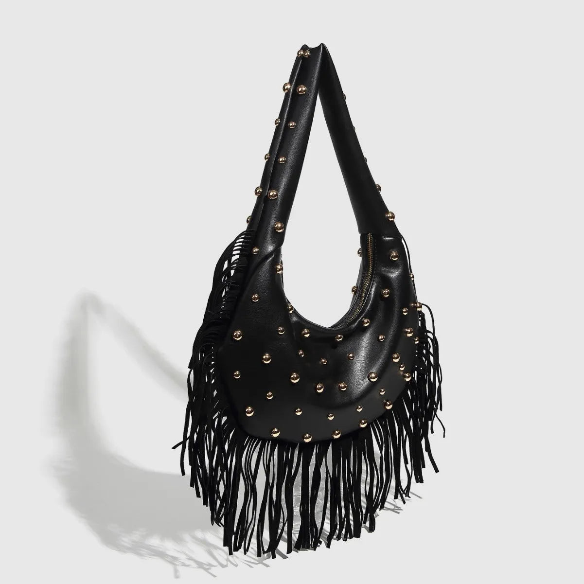 Retro tassel shoulder handbag in black with mobile phone compartment visible