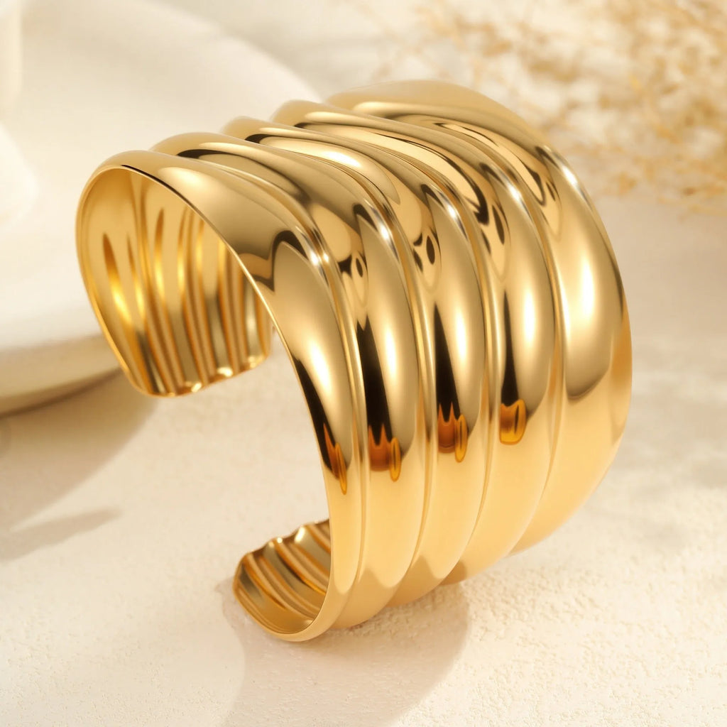 Women's wide fashion bracelet with geometric wave design in gold plating on stainless steel