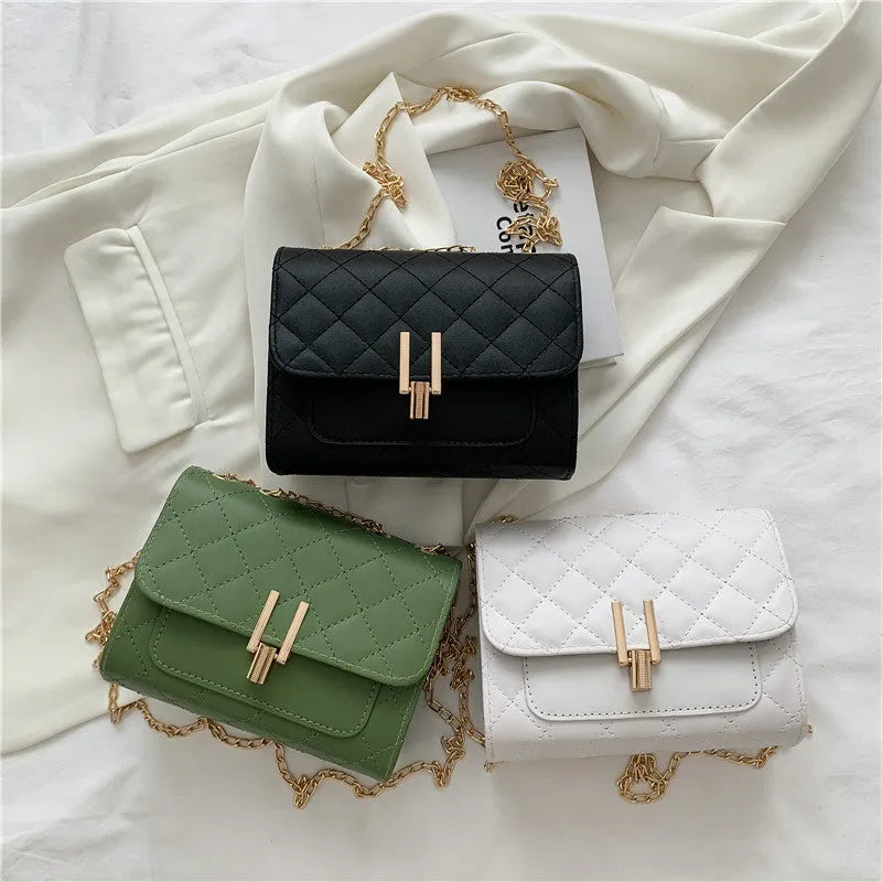 Women's black PU leather crossbody bag with diamond lattice chain detail and adjustable shoulder strap