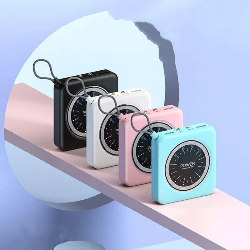 Mini clock portable power bank in an alloy case with multiple USB ports, shown in mint green colour.