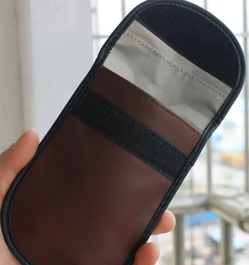 Black microfiber RFID signal blocker bag shown closed, measuring 13.5 by 9.5 centimetres.
