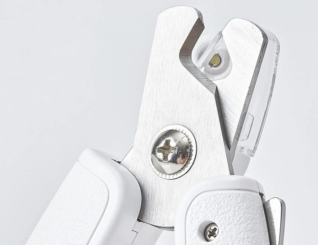 White LED pet nail clipper with transparent splash guard and triangular blade for cats and dogs