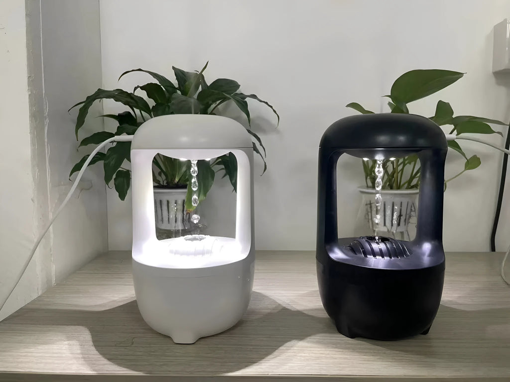 Anti-gravity humidifier with water droplet effect on desk next to USB cable