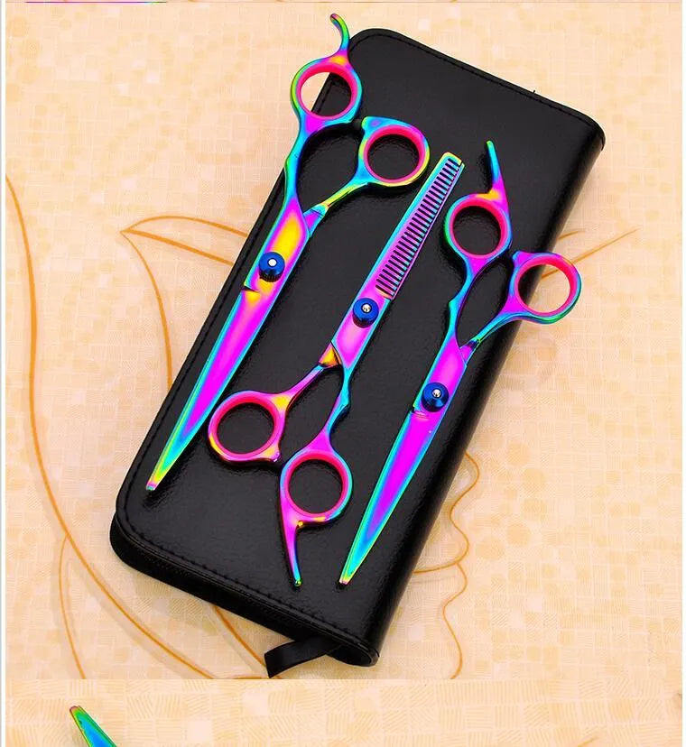 Three pet grooming scissors with purple handles on white background including curved flat and tooth shears