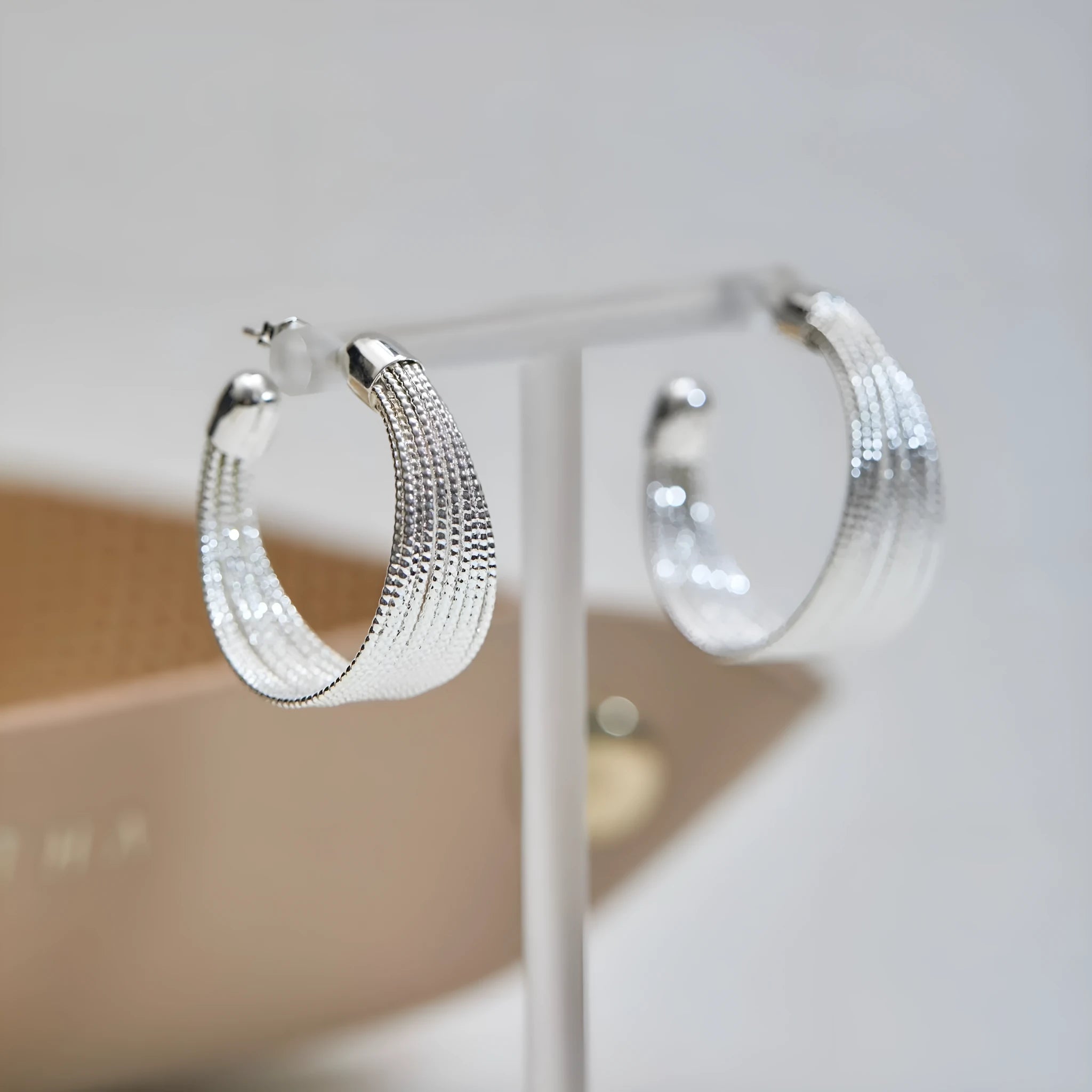 Geometric copper earrings with electroplated silver or gold finish, shown as stud and clip-on styles