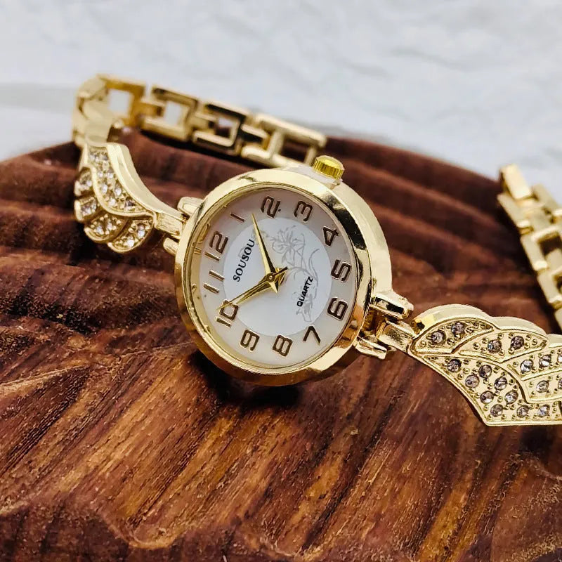 Women's stainless steel watch with round dial showing gold surface colour and vachette clasp