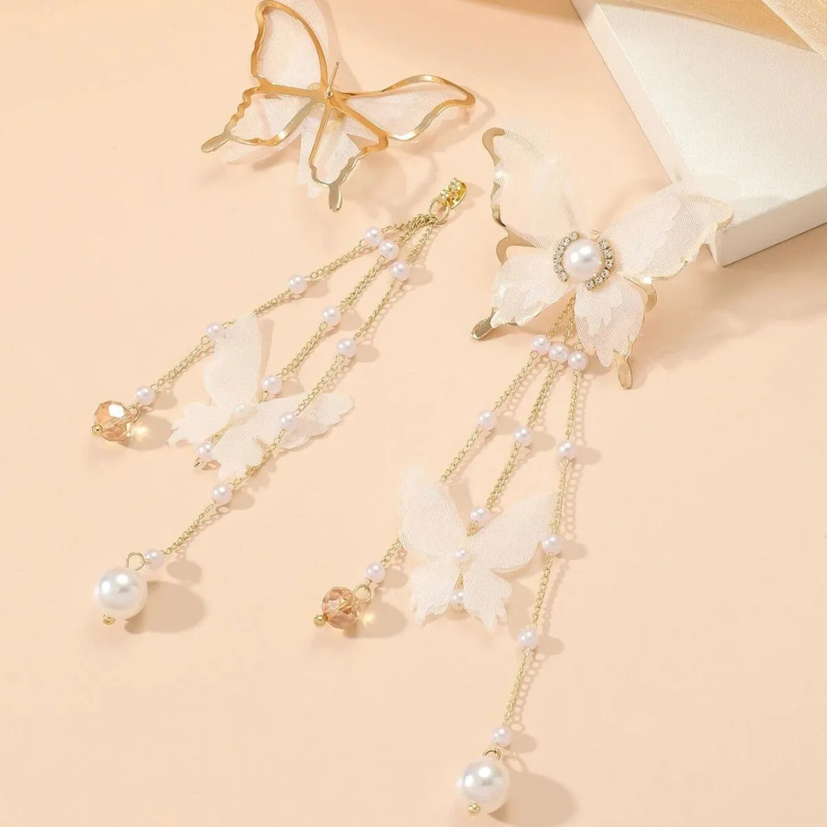 White butterfly earrings with tassel lace and pearl rhinestone decorative elements on copper alloy