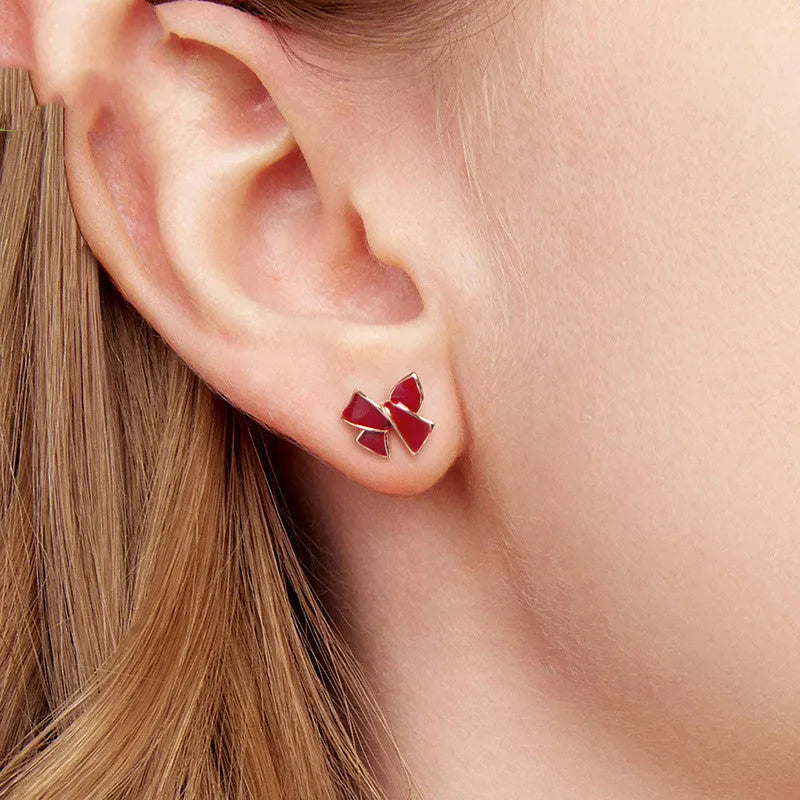 Pair of silver 925 sterling silver bow stud earrings with wine red finish on white background