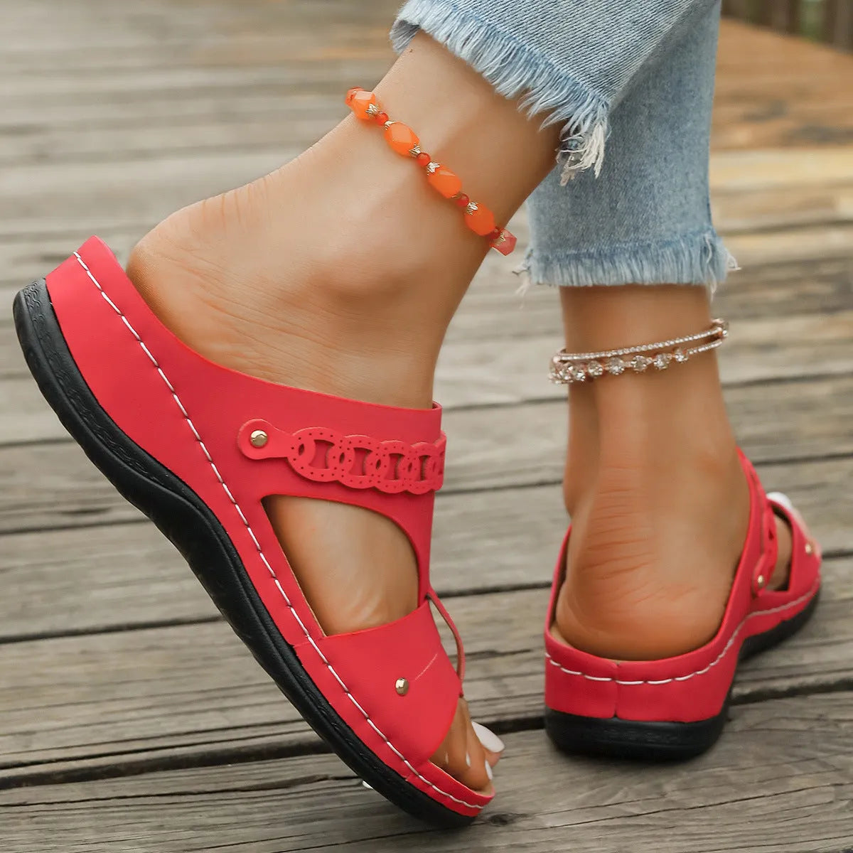 Pair of blue Roman-style slope heel slippers showing fish mouth toe holder design.