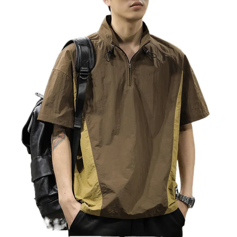A brown men's loose-fit short-sleeve shirt with a half-zip front and stand collar.