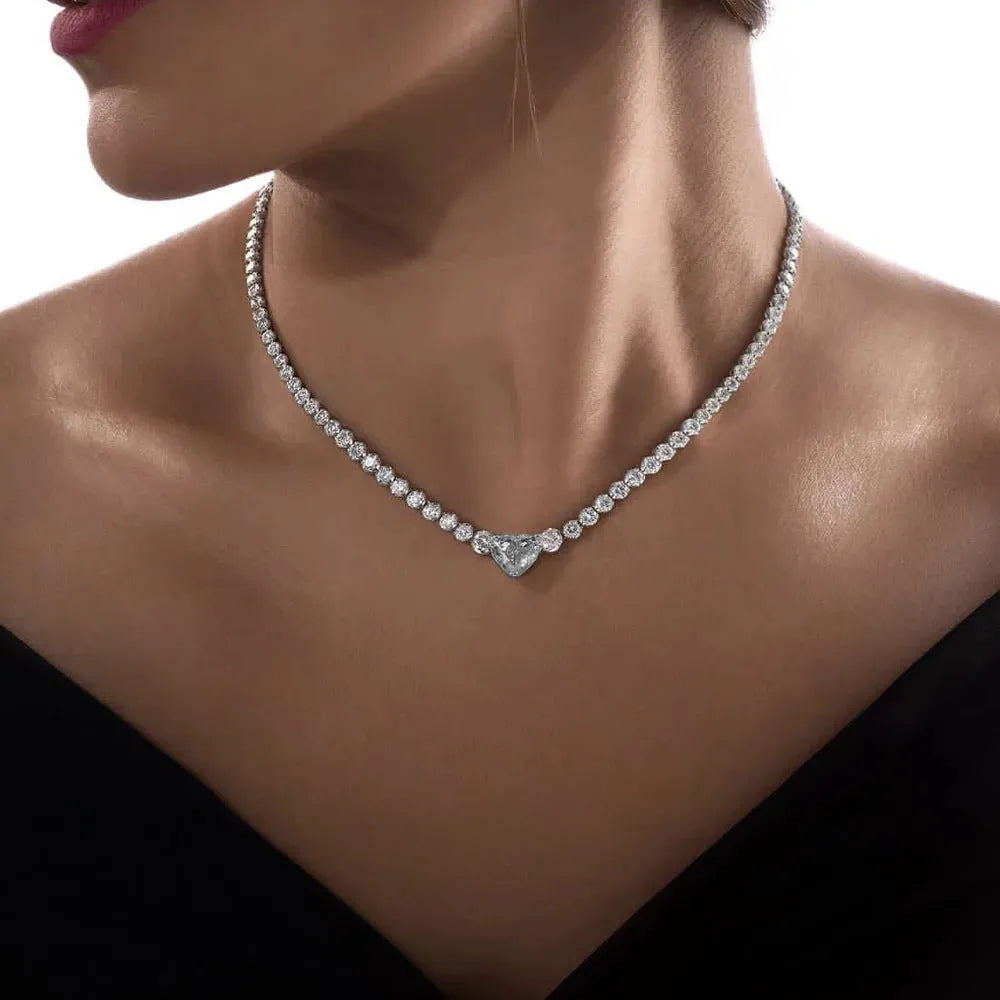 Heart pendant necklace with rhinestone crystal on a 41-50cm box chain, available in gold or silver finish.