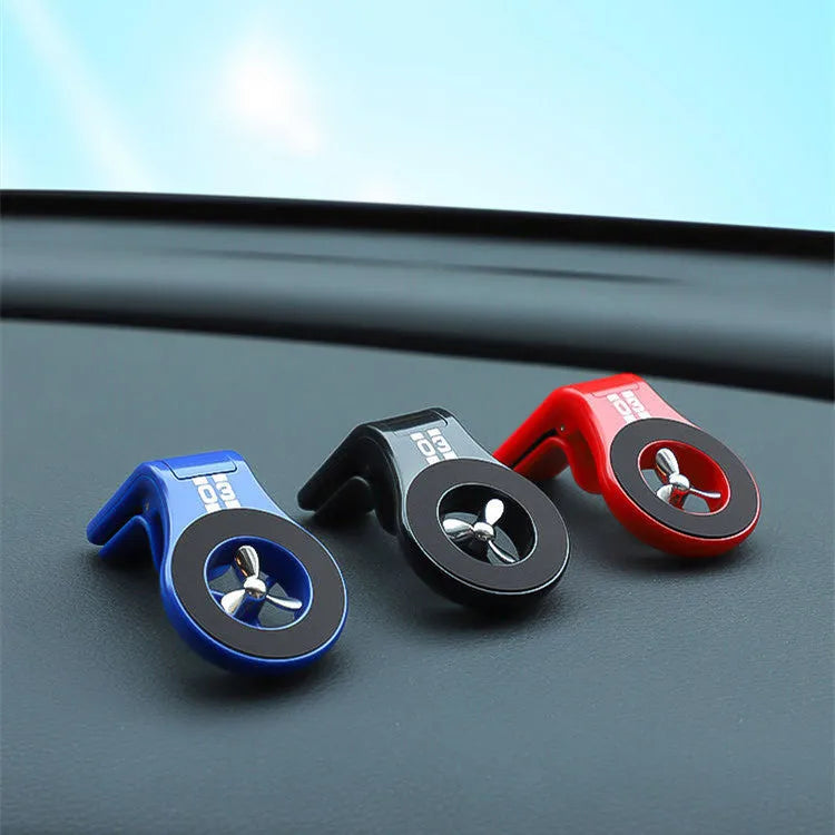 Magnetic car phone holder with fragrance diffuser clipped to car air vent