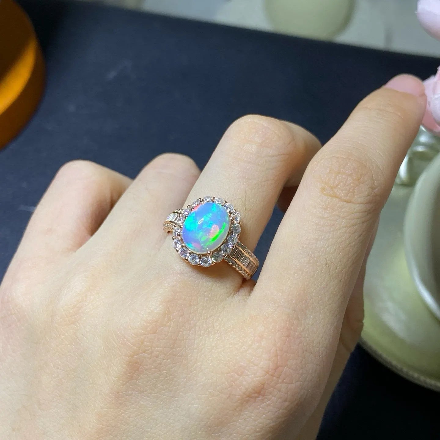 Handmade adjustable silver ring with a natural opal stone in rose gold plating.