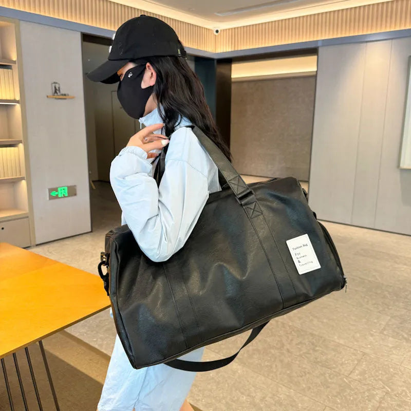 Black fitness shoulder messenger bag showing dry wet separation compartment and shoulder strap.