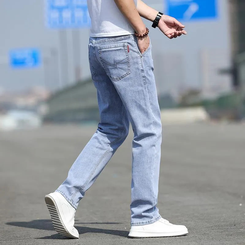 Men's straight-leg jeans in smoky grey colour with low waist design and zipper fly closure