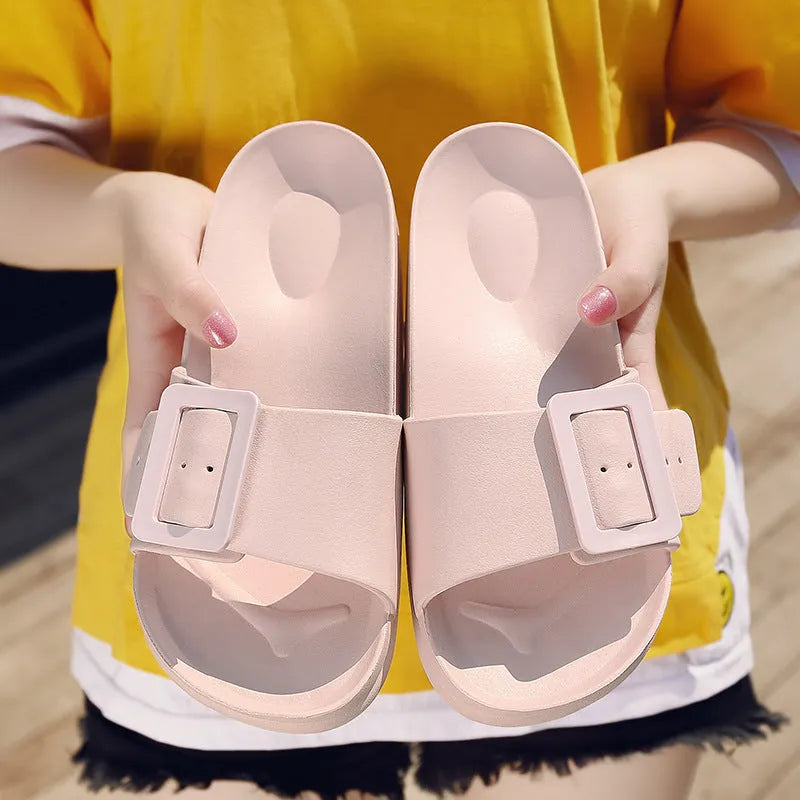 Women's grey blue buckle flip-flop sandals with a soft EVA sole on a plain background