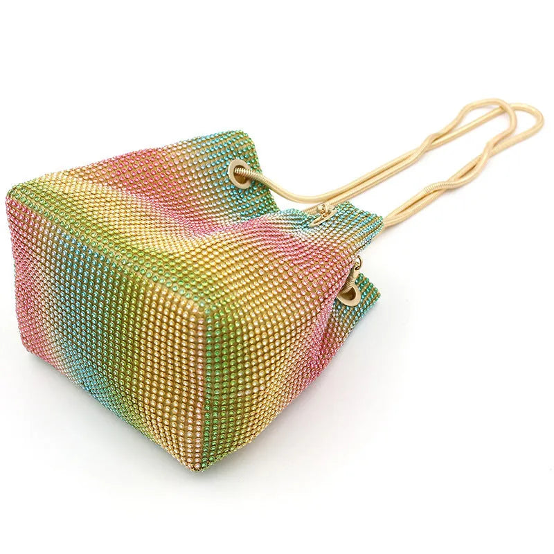 Rhinestone bucket bag with diamond studded design and rainbow chain strap