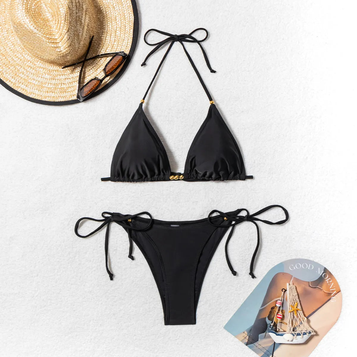 Black women's bikini swimsuit with metallic bead detail and split-front design