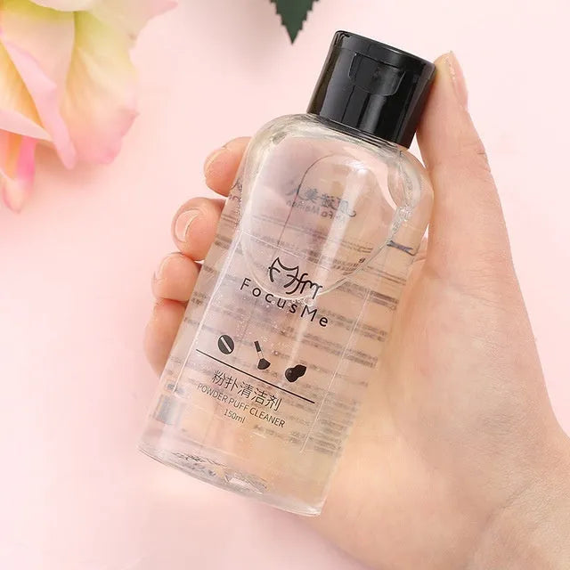 50ml makeup brush cleaning liquid in a clear bottle with a white cap, next to a makeup brush