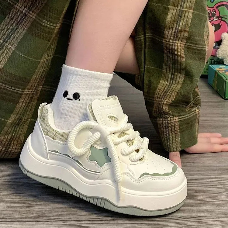 Women's green patent leather platform sneaker with lace-up front and round toe design on rubber sole