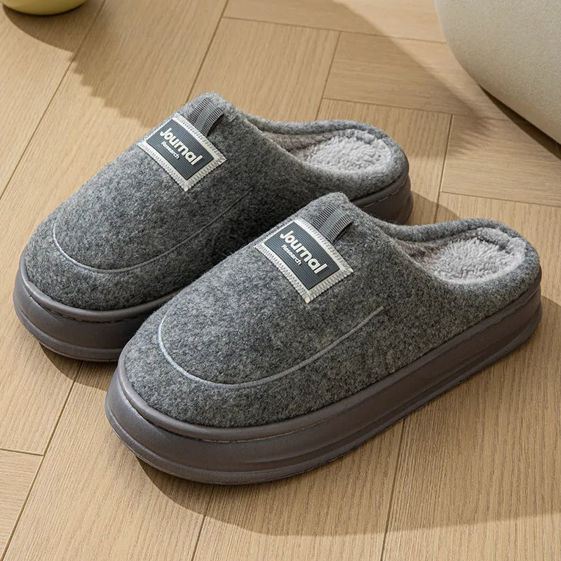Men's brown suede slippers with thickened sole on wooden floor