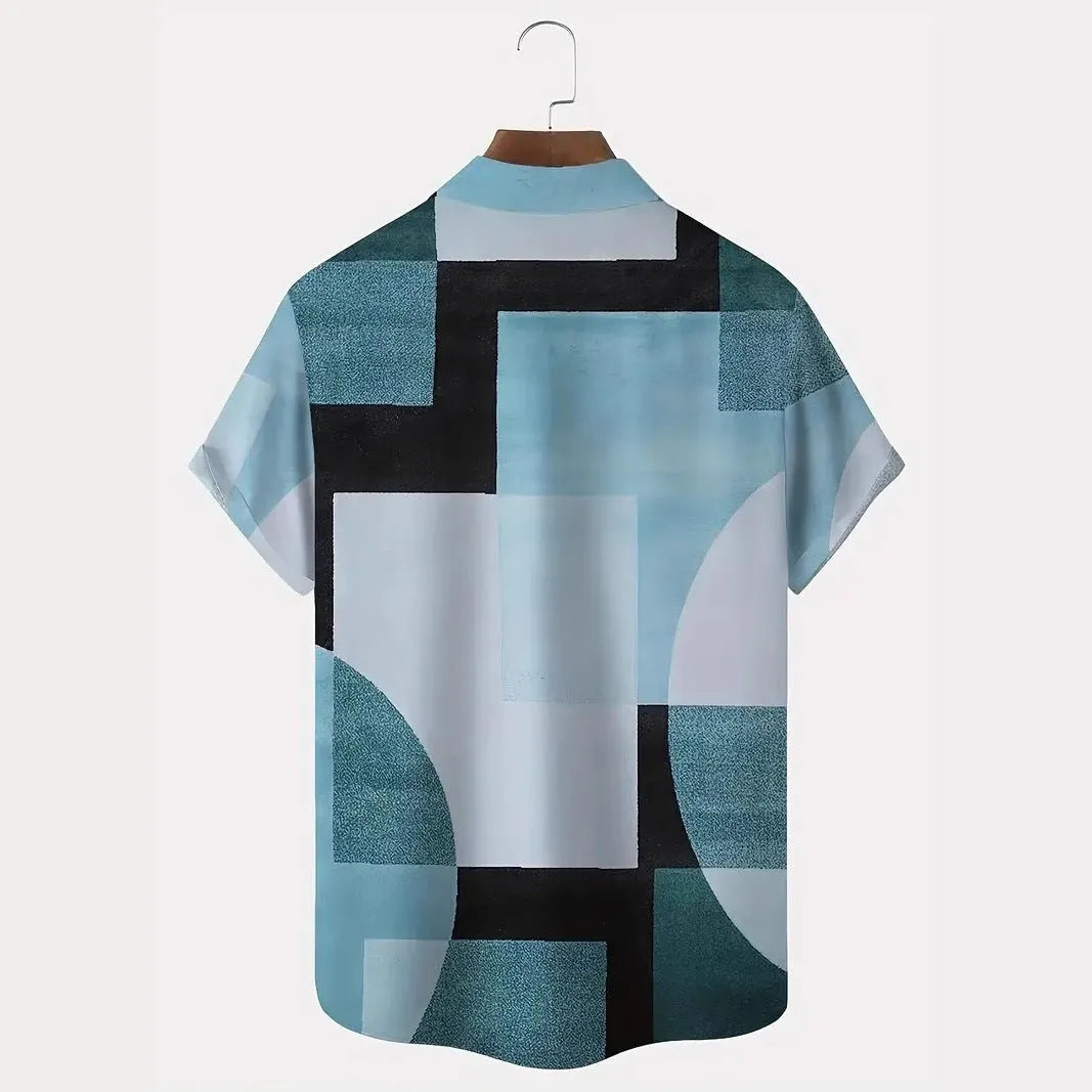 Man wearing a short sleeve cardigan with a blue and white retro geometric square print pattern.