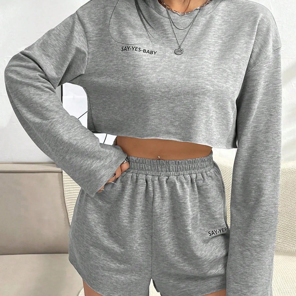 Grey women's long-sleeved t-shirt and matching shorts loungewear set laid flat.