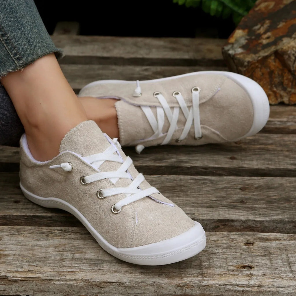 Women's low-top beige fabric casual sneakers on a white background.