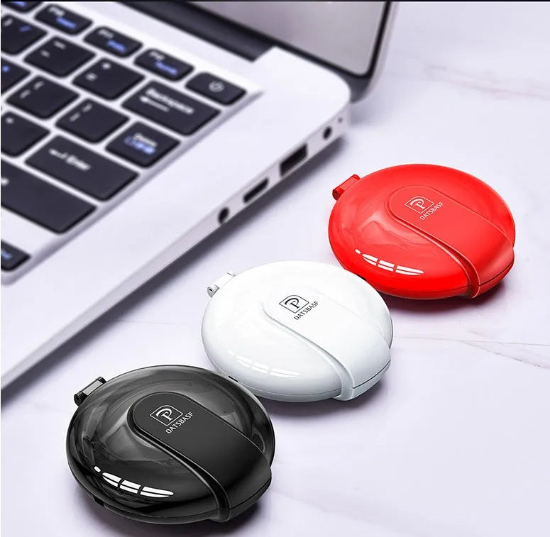 Black magnetic 3-in-1 car phone holder and portable charger with retractable cable on a car dashboard.