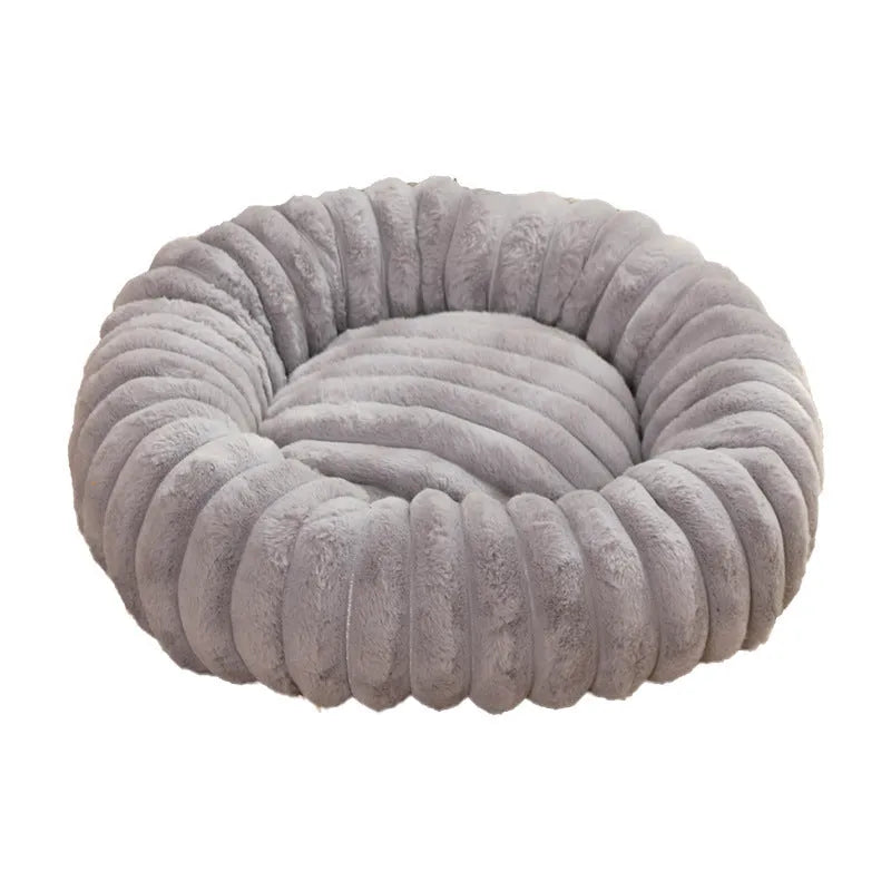 Round long plush dog bed in gray on floor, super soft warm pet sofa with raised edges