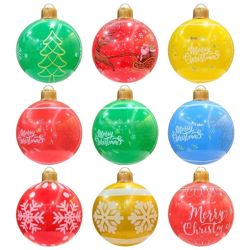Large red inflatable Christmas ball with gold snowflake design hanging in garden with LED lights illuminated
