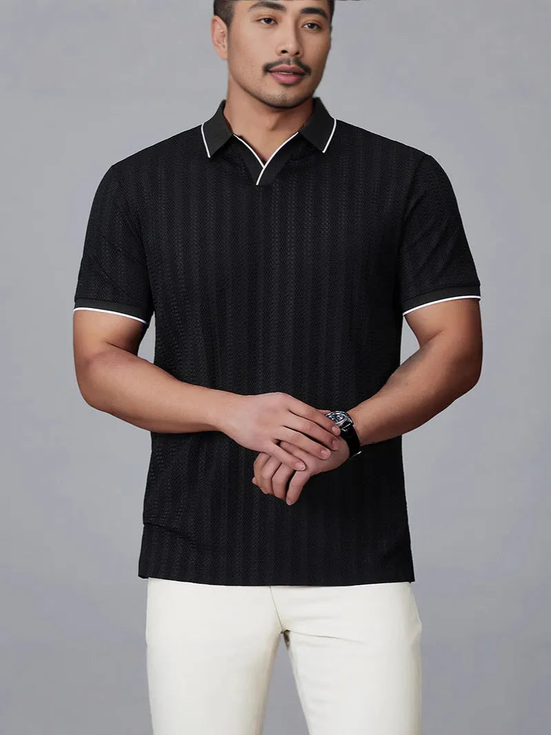 Man wearing a loose-fit black nylon polo shirt, short sleeves, casual style.