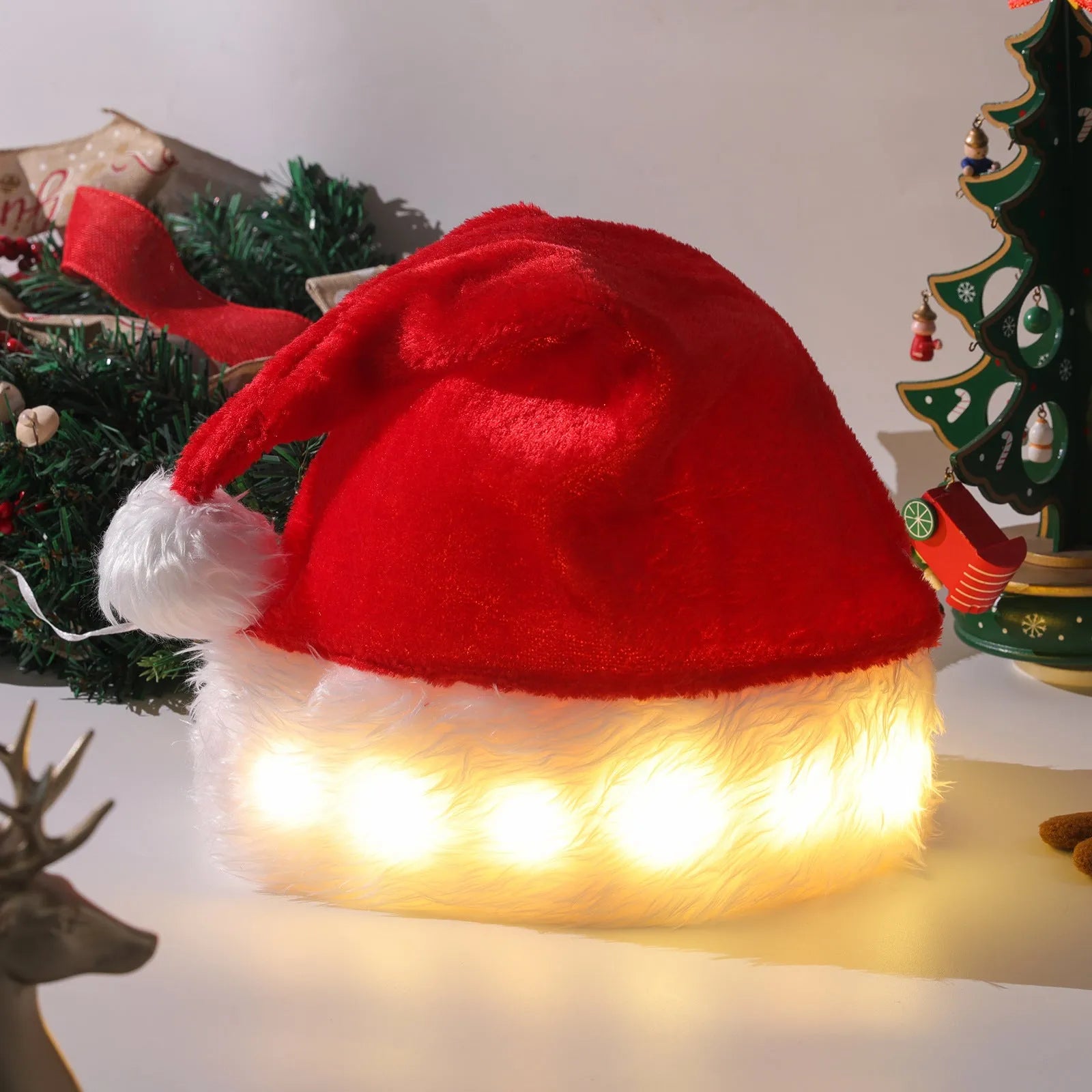 Red and white plush Santa hat with 20 multicolour LED lights glowing around its base and a white pom pom.