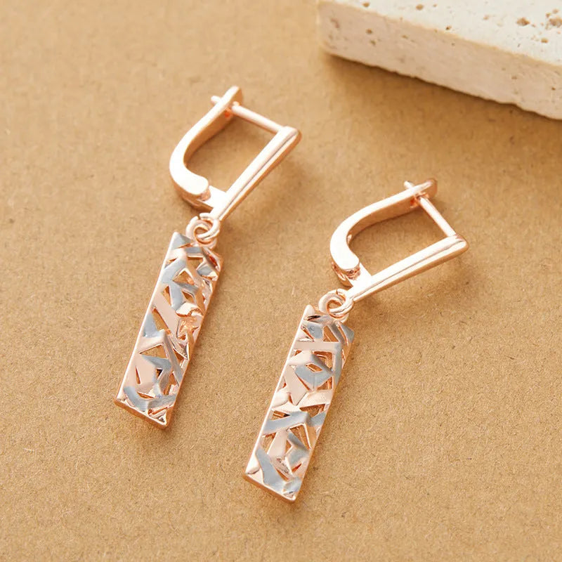 A pair of rectangular two-tone hollow stud earrings with a geometric design and picture-style colour finish.