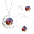 Tree of Life jewellery set with alloy and glass gem pendants: necklace, earrings, and bracelet on display
