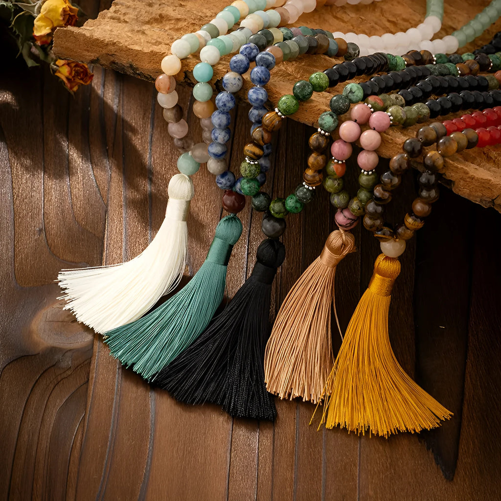 Vintage bohemian style long bead necklace with tassel and matching bracelet on grey background