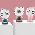 Cartoon animal table lamp in plastic, available as a bear, cow, rabbit, or tiger design.